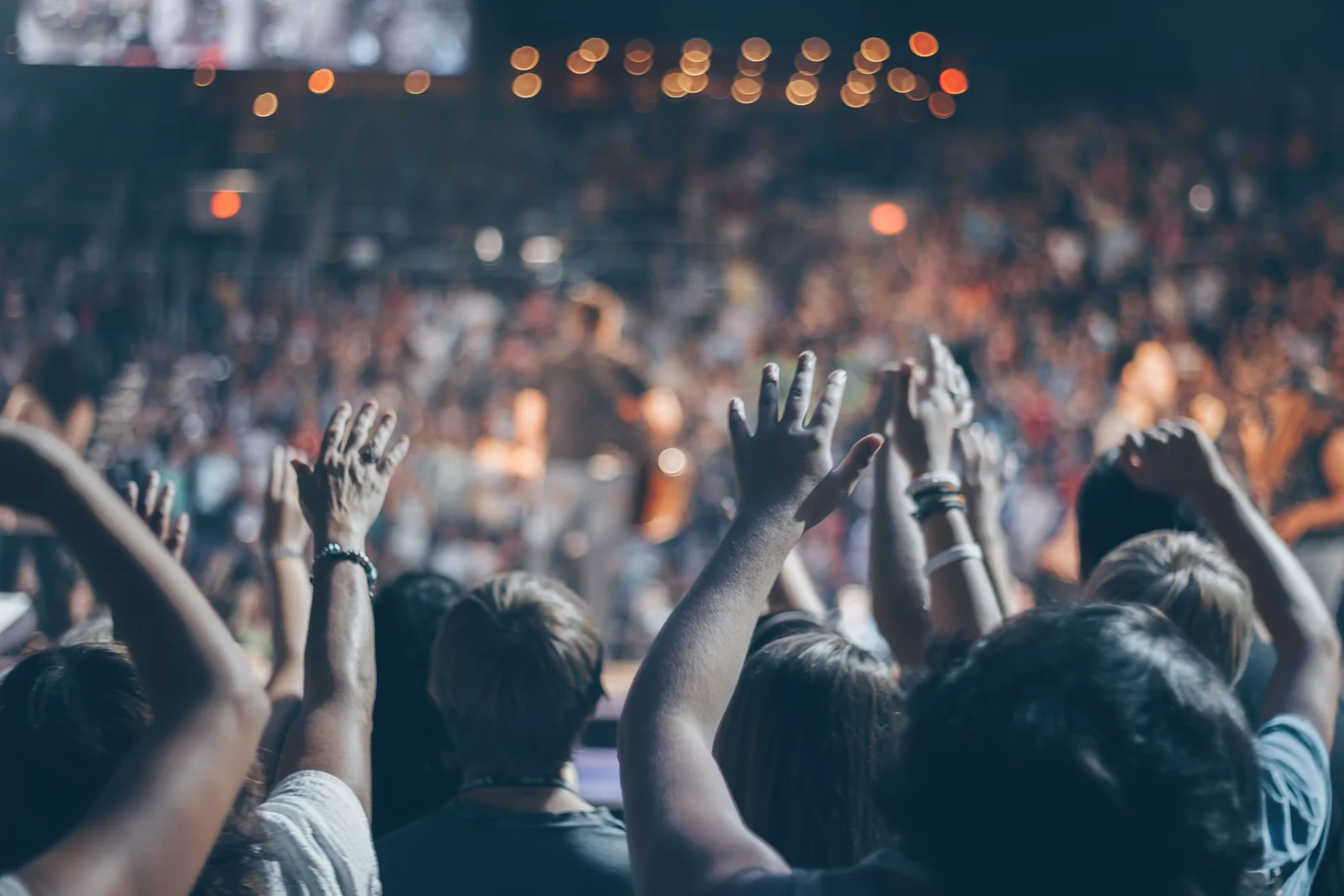 A gathering with hands raised